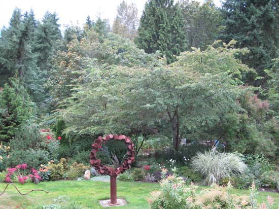 to the left of the sculpture is a pathway leading to the gardens below